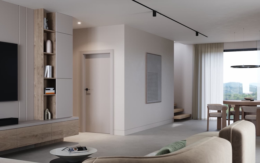 salon z białymi drzwiami i czarną klamką